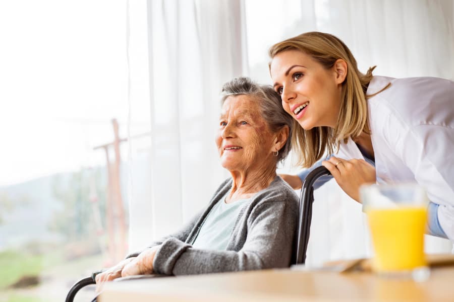 Caregiver on a home visit with senior patient