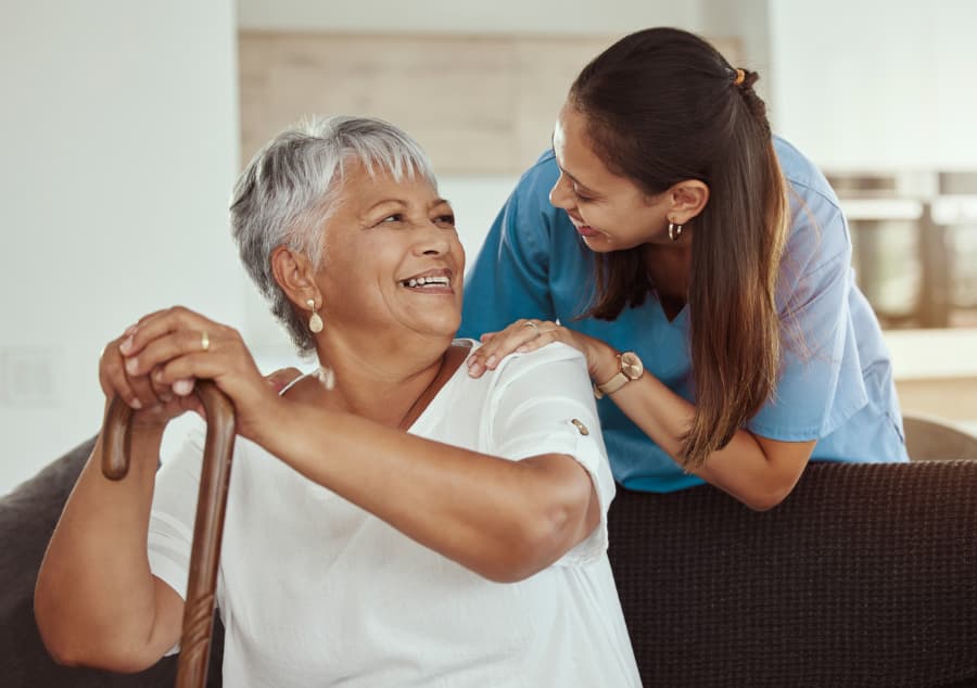 Caregiver and patient laughing together while getting to know one another